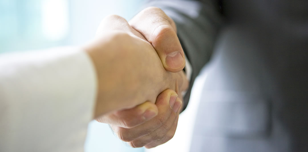 Image of a handshake between two business people indicating trust when it comes to business